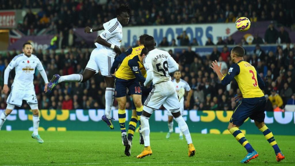 Swansea’s Bafetimbi Gomis heads home the winning goal in the Premier League game against Arsenal at the Liberty Stadium. Photograph: Stu Forster/Getty Images