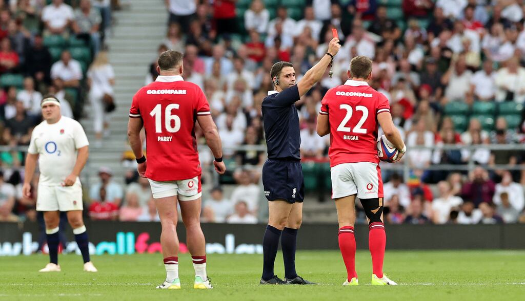 Nika Amashukeli, the referee, shows Owen Farrell, the England captain, a red card as he sits in the sin bin during the summer International clash against Wales at Twickenham. Photograph: David Rogers/Getty Images