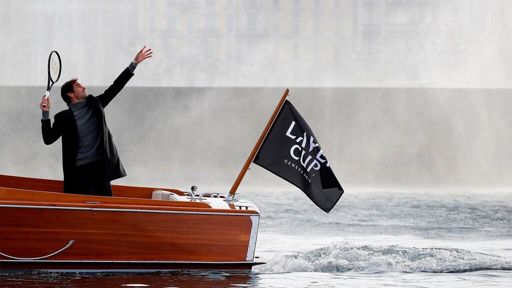 Roger Federer serves a ball towards the Jet D’Eau on a boat   in Geneva during a presentation ahead of the Laver Cup tournament that will take place   next September. Photograph: Getty Images