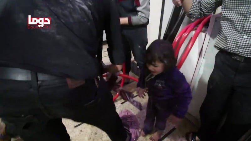Unidentified volunteers spraying a girl with water at a makeshift hospital following an alleged chemical attack in Douma, Syria. Photograph: AFP Photo/Douma City Coordination Committee
