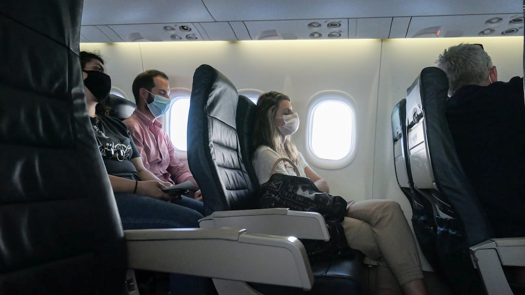 Passengers wearing face masks on an Olympic Air De Havilland Canada aircraft flying from Athens. Certain factors on board, such as raised seat backs, can help lessen virus transmission. Photograph: Nicolas Economou/ NurPhoto via Getty Images