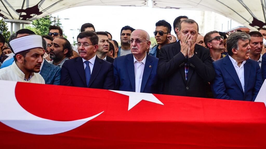 Former Turkish president Abdullah Gul, Turkish president Recep Tayyip Erdogan, Turkey’s Grand National Assembly president Ismail Kahraman  and former PM Ahmet Davutoglu attend the funeral service for victims of the thwarted coup in Istanbul, Turkey. Photograph: Burak Kara/Getty Images
