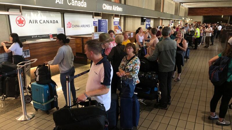 Passengers from an Australia-bound Air Canada flight diverted to Honolulu wait to rebook flights. Photograph: AP/Caleb Jones