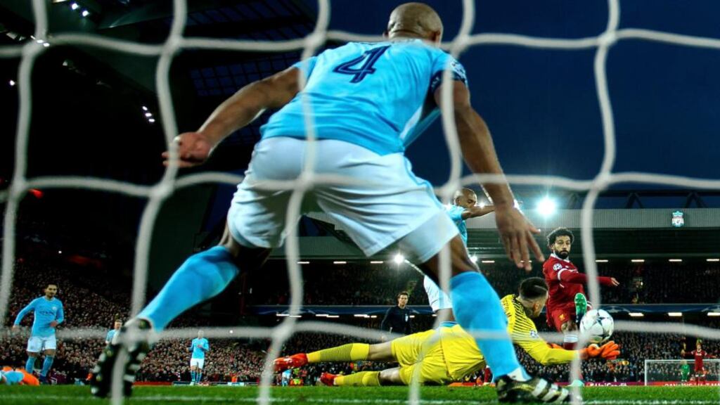 Mohamed Salah scores Liverpool’s 1-0 lead during the Uefa Champions League quarter-final first leg match against Manchester City at Anfield on Wednesday. Photograph: Peter Powell/EPA