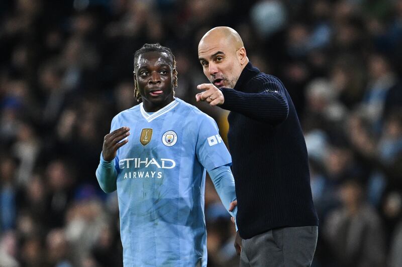 Manchester City's manager Pep Guardiola (R) gives instructions to Jeremy Doku. Photograph: Paul Ellis/AFP via Getty Images =