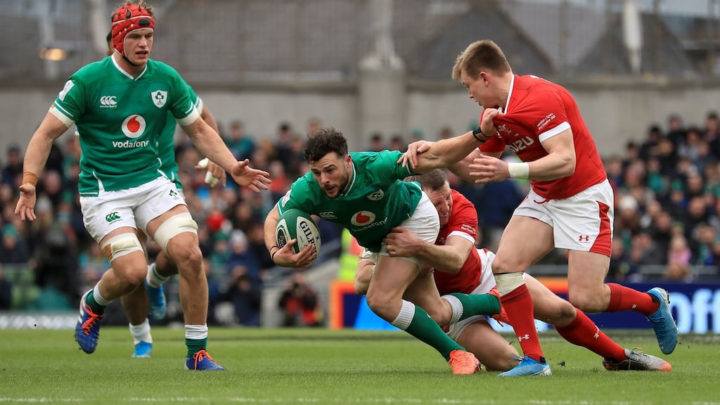 Robbie Henshaw is tackled by Hadleigh Parkes during Ireland’s win over Wales. Photograph: Donall Farmer/PA