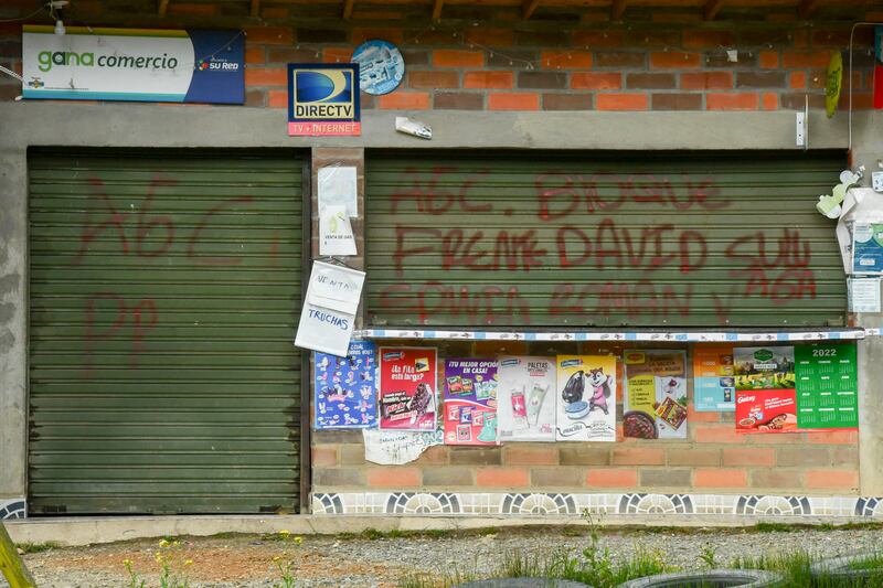 A house daubed with graffitti supporting Clan del Golfo, near San Pedro de los Milagros, Antioquiat, Colombia. Photograph: Joaquin Sarmiento/AFP via Getty Images