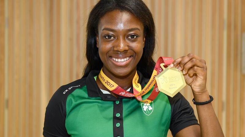 Gina Akpe-Moses shows off her gold medal from the 100m at the European Athletics Under-20 Championships in Italy on the Ireland squad’s return at Dublin Airport. Photograph: Sam Barnes/Sportsfile
