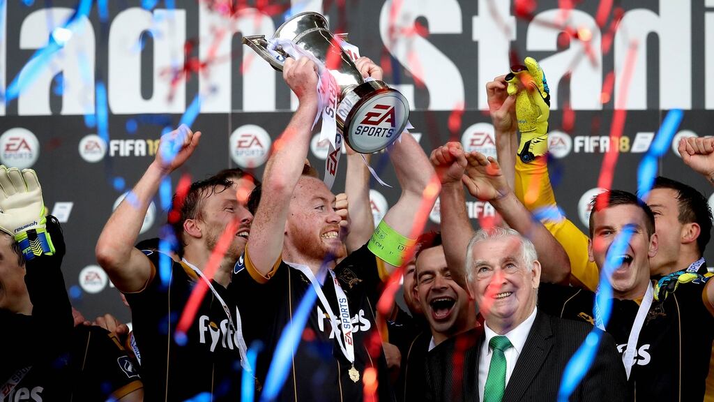 Dundalk’s Chris Shields lifts The EA Sports Cup. Photograph: Ryan Byrne/Inpho