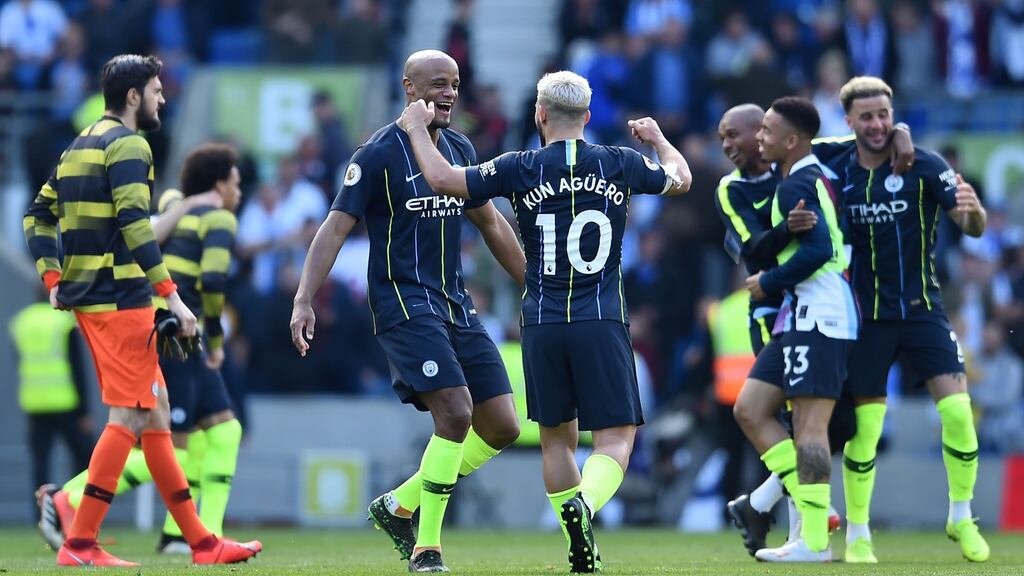Manchester City celebrate after securing the title with a 4-1 win over Brighton. Photograph: Glyn Kirk/AFP/Getty