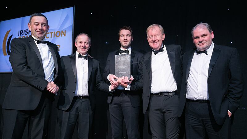 Shane Lannon, Director, Lumen Search, presents the Construction Project of the Year award to the John Paul Construction team.