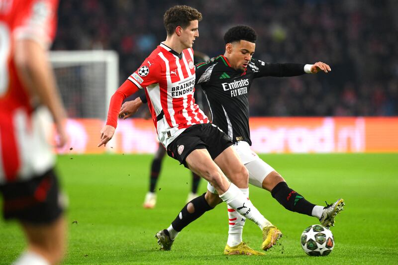PSV Eindhoven's Guus Til is challenged by Arsenal's Ethan Nwaneril during the Champions League Round of 16, first leg at the Philips Stadion. Photograph: John Thys/AFP via Getty Images