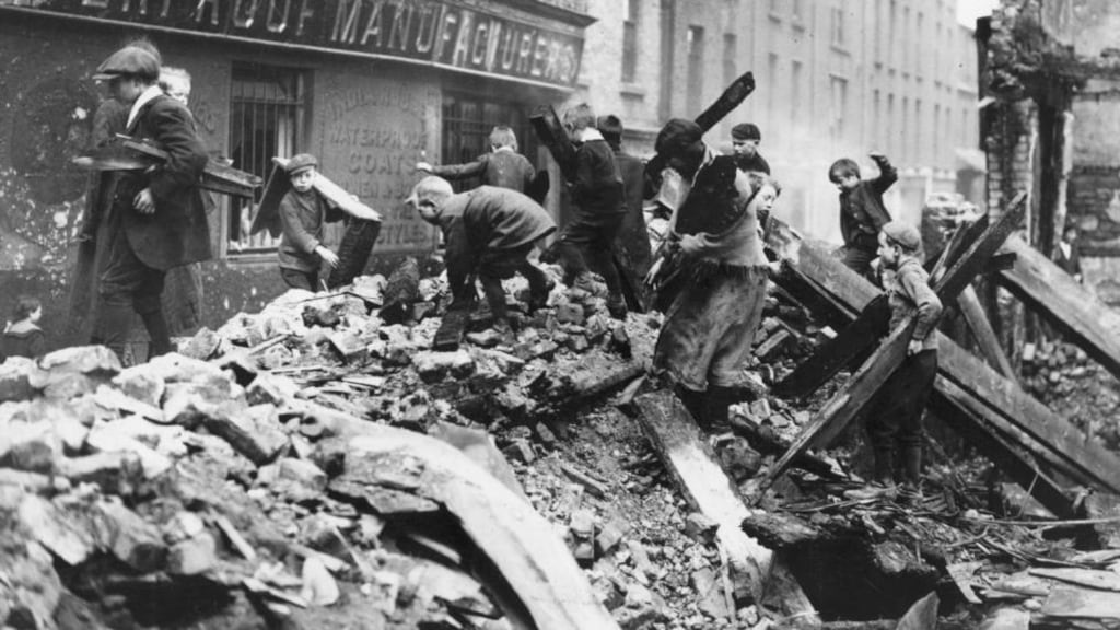 Poor children of Dublin collecting firewood from the ruined buildings damaged in the Easter Rising. Photograph: Central Press/Getty Images