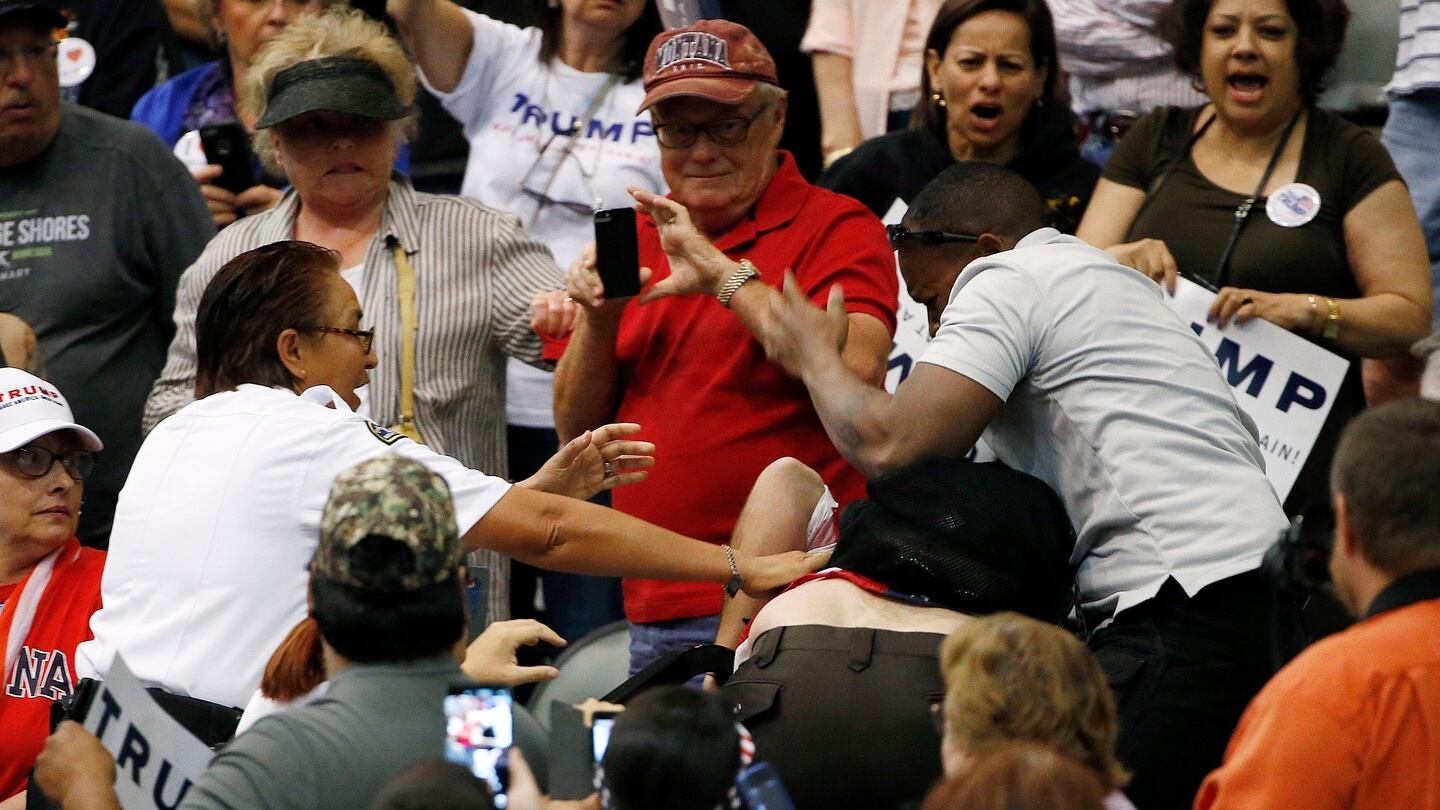 A supporter of Republican presidential candidate Donald Trump, right, scuffles with an anti-Trump protester, as security (left) intervenes before Mr Trump spoke at a campaign rally on Saturday. Photograph: AP