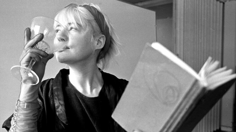 Glass half full: Evelyn Byrne performs at an event in 1989 in Dublin where women writers, artists and performers  displayed and discussed their creativity. Photograph: Paddy Whelan
