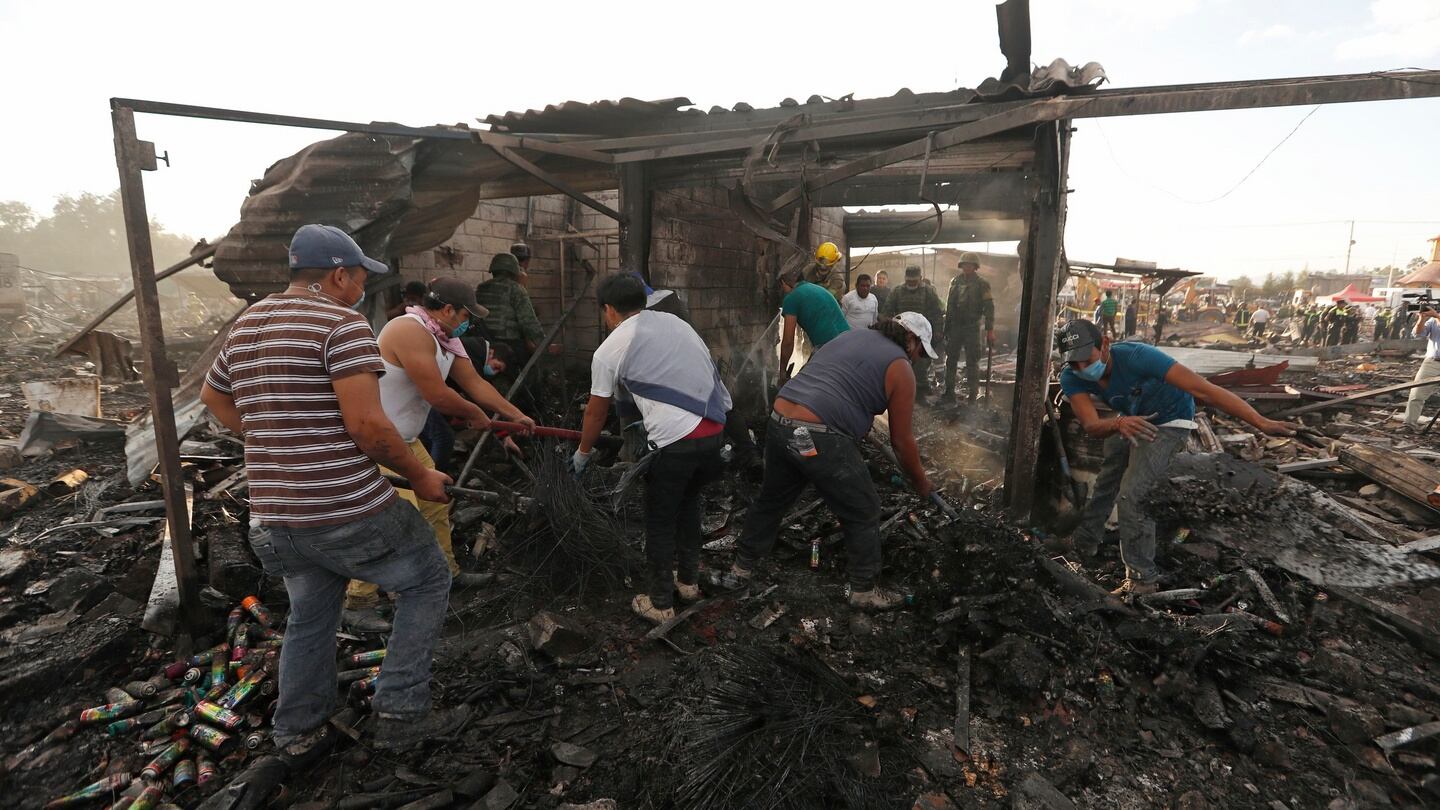 Residents comb through ashes and rubble at the scorched ground of Mexico’s best-known fireworks market after an explosion explosion ripped through it, inTultepec, Mexico, on Tuesday. Photograph: AP