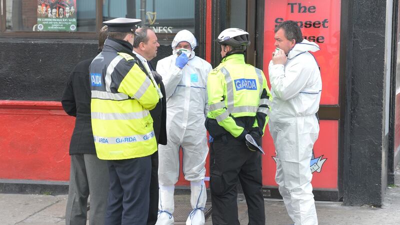 Gardaí and forensic team at the Sunset House, Summerhill on Tuesday morning. Assistant commissioner John Twomey said the resolve of his officers would not be shaken by the recent upsurge in violence in the capital. Photograph: Cyril Byrne/The Irish Times
