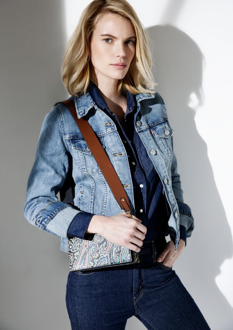 Denim jacket (was €110, now €77), denim shirt (was €80, now €56), jeans (were €100, now €70), all at the Levis store. Paisley print leather handbag at DVF (was €365, now €219), earrings at Links of London (were €160, now €110)