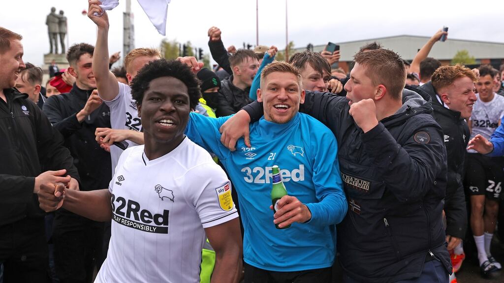 Martyn Waghorn of Derby County celebrates with fans outside the stadium after they secured their place in the Championship. However, Wayne Rooney’s side could still eb relegated. Photo: Alex Pantling/Getty Images