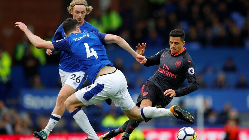 Arsenal’s Alexis Sanchez in action with Everton’s Michael Keane and Tom Davies. Photograph: Phil Noble/Reuters
