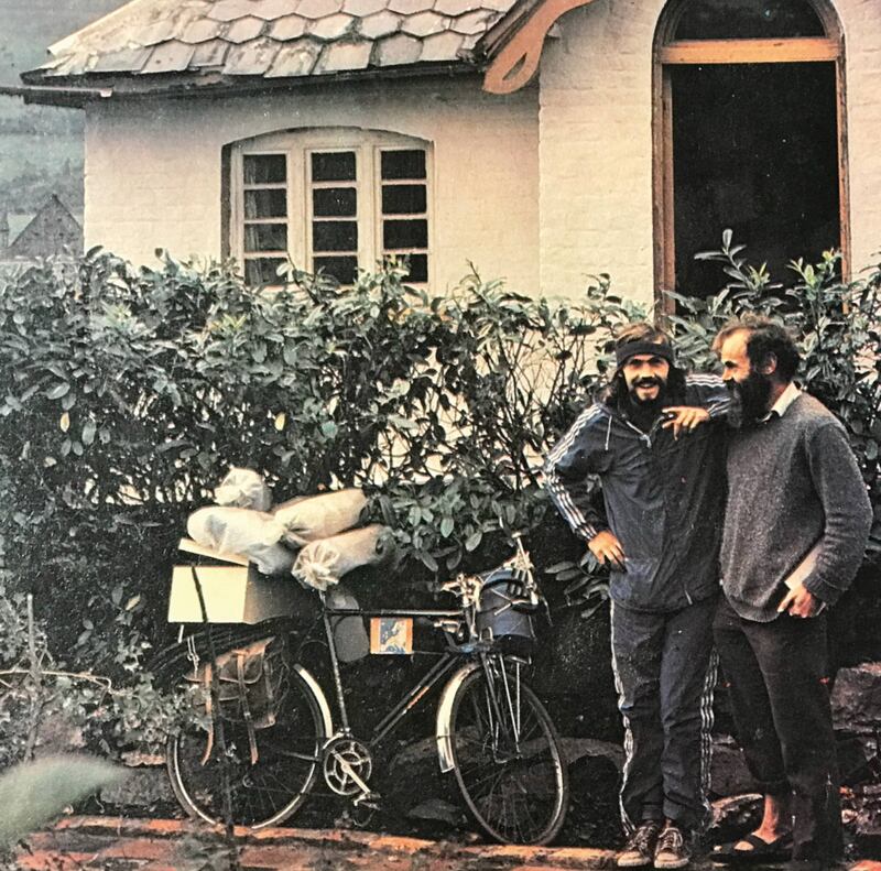 Jean-Luc, with his heavily packed push-bike, talks to a friend in Belfast on his European tour in 1979