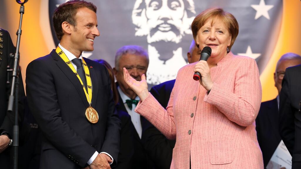 France’s Emmanuel Macron and German’s Angela Merkel at the Charlemagne Prize ceremony on Thursday in Aachen. Photograph: Ludovic Marin/AFP/Getty Images