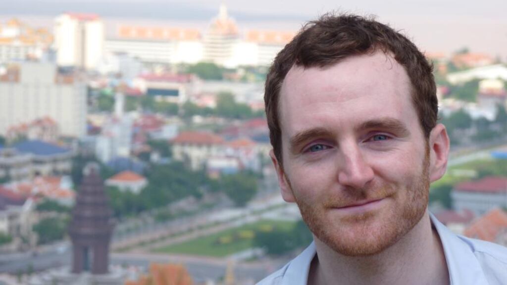 Irish barrister Coman Kenny, with the skyline of Phnom Penh in the background