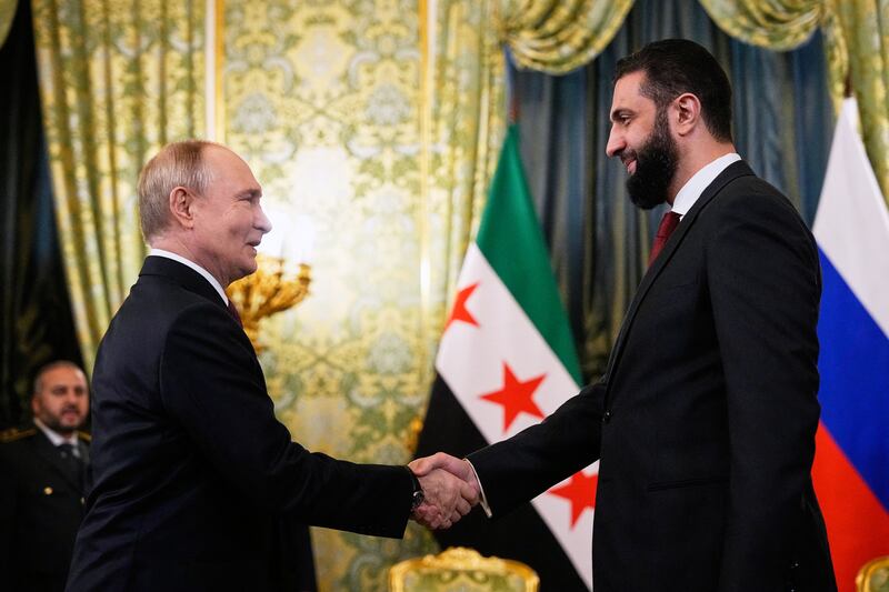 Vladimir Putin and Ahmed al-Sharaa shake hands during their meeting at the Grand Kremlin Palace in Moscow. Photograph: Alexander Zemlianichenko/AFP via Getty Images