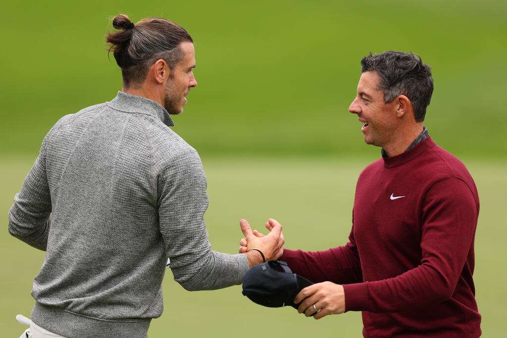 Rory McIlroy and Gareth Bale embrace on the 18th green after playing in the pro-am prior to the BMW PGA Championship at Wentworth. Photograph: Andrew Redington/Getty Images