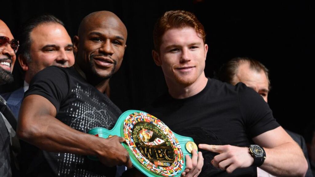 Floyd Mayweather Jr (left) and Canelo Alvarez hold a WBC super welterweight championship belt during the final news conference for their bout at the MGM Grand Hotel/Casino. Photograph: Ethan Miller/Getty Images