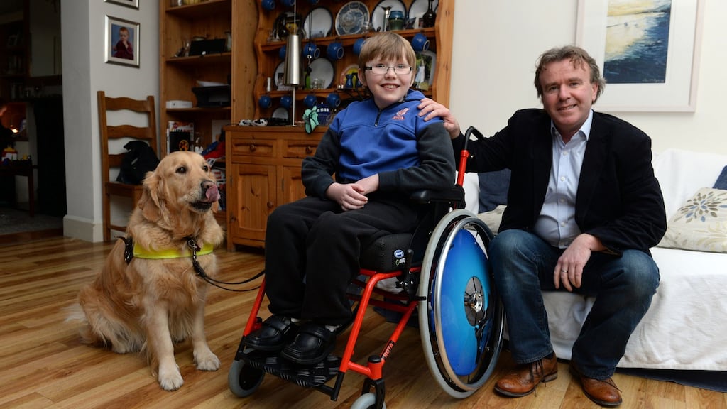 Tom Clonan, his son Eoghan (13) and Eoghan’s care dog Duke. Photograph: Cyril Byrne