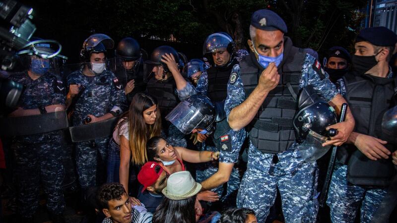 Riot policemen try to remove anti-government protesters blocking a road in front of the Lebanese interior ministry during a protest against an economic and financial crisis, in the al-Hamra area of Beirut, Lebanon, in recent weeks. Photograph: Nabil Mounzer/EPA
