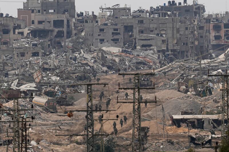 Israeli troops walk through the destruction in the Gaza Strip. Photograph: Ohad Zwigenberg/AP
