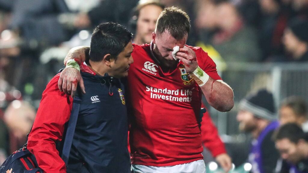 Lions’ Stuart Hogg goes off with a blood injury with physio Prav Mathema during their win over the Crusaders. Photo: Billy Stickland/Inpho