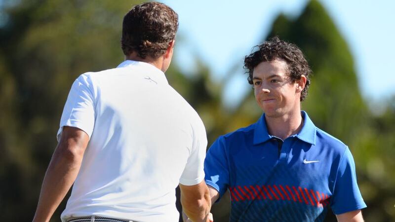 Rory McIlroy is congratulated by home-hope Adam Scott after clinching victory. Photograph: Getty Images