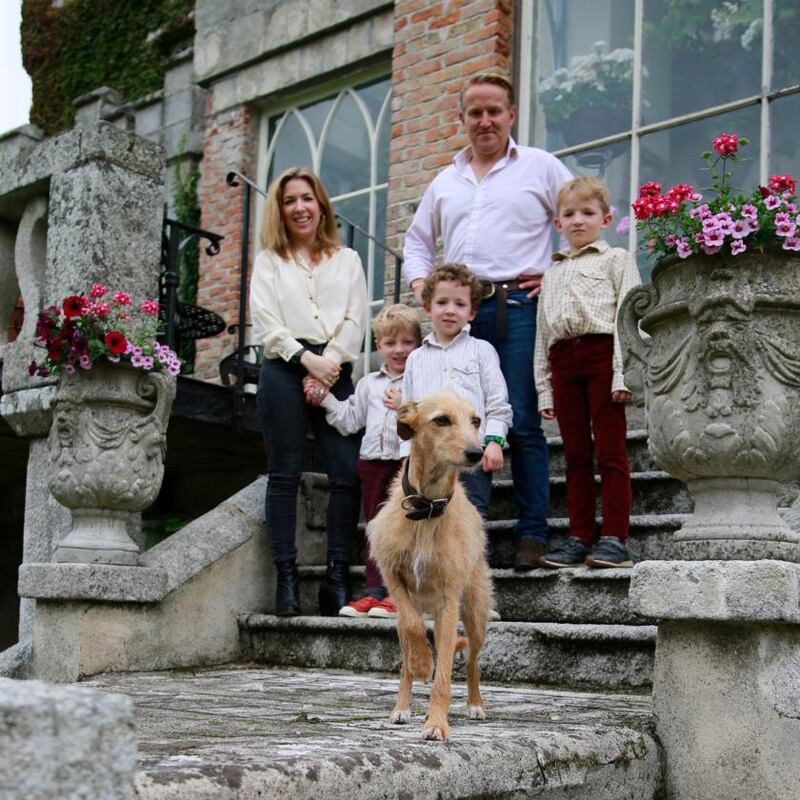 Huntington Castle: Clare and Alex Durdin Robertson with their children, five-year-old Freddie, seven-year-old Esmonde and eight-year-old Herbert, with their dog Myrtle. Photograph: Nick Bradshaw