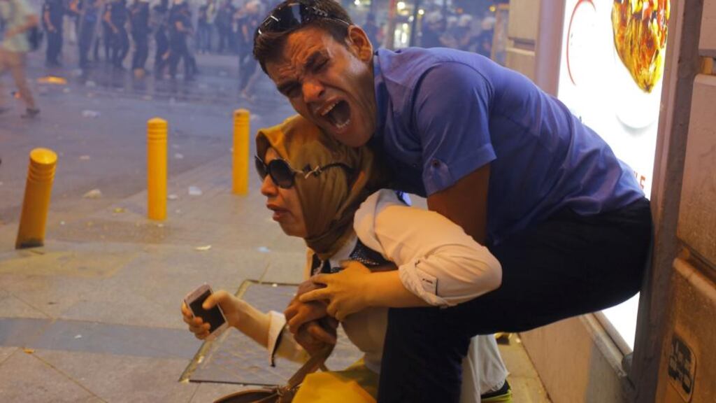 A couple, affected by tear gas used by riot police to disperse demonstrators, in Istanbul, yesterday. Photograph: Huseyin Aldemir