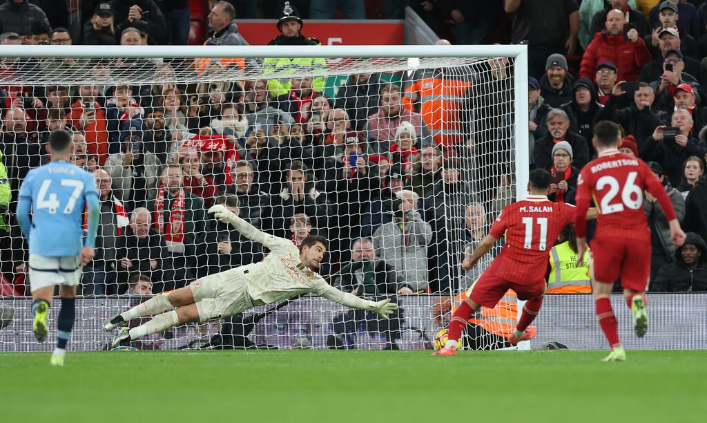 Mohamed Salah of Liverpool scores his team's second goal from the penalty spot. Photograph: Carl Recine/Getty