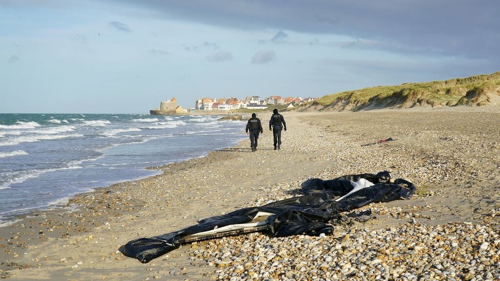 French police officers patrol the beach in Wimereux, near Calais: On Friday the first of the 27 people who died after a vessel capsized in the Channel was named as a young Kurdish woman. Photograph: Gareth Fuller/PA Wire