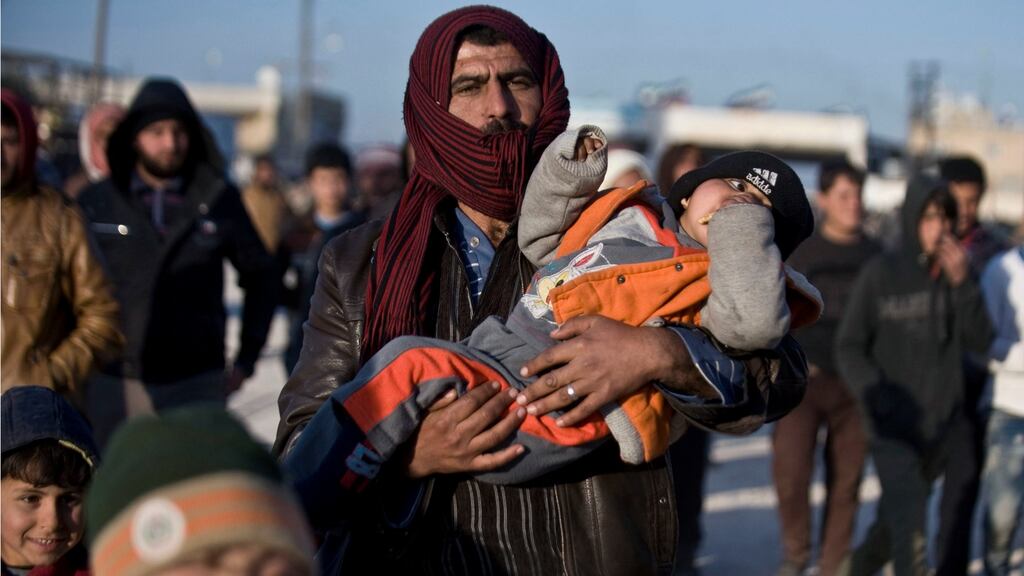 Syrians fleeing the battle for control of Aleppo walk towards the Turkish border at the Bab al-Salam border gate, on February 5th. The districts held by anti-governmetn forces in Aleppo are a prize they dare not lose. Photograph: Depo Photos via AP