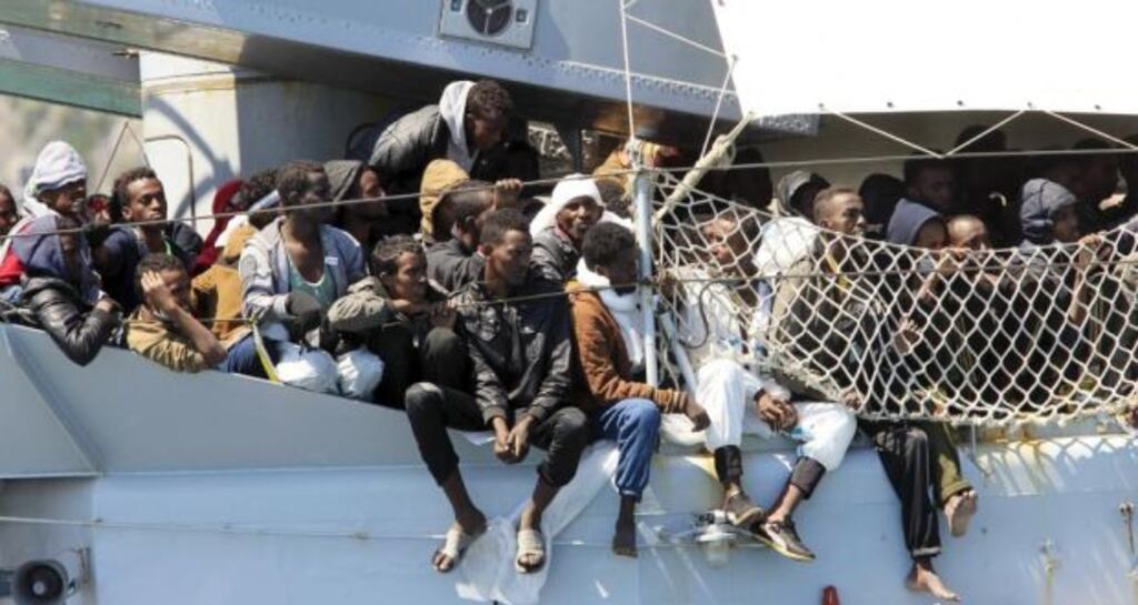Migrants on board of Italian Navy ship ‘Chimera’ before disembarking in the southern harbour of Salerno. Photograph: Ciro De Luca/Reuters