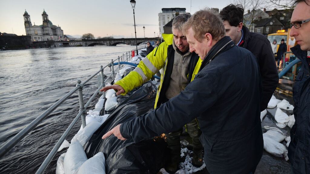 Taoiseach Enda Kenny examines flood defences on the banks of the east side of the river Shannon in Athlone in December. Photograph: Alan Betson/The Irish Times