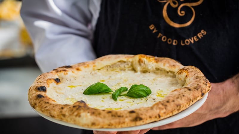 The ice on the cacio e pepe pizza evaporates in the heat of the oven