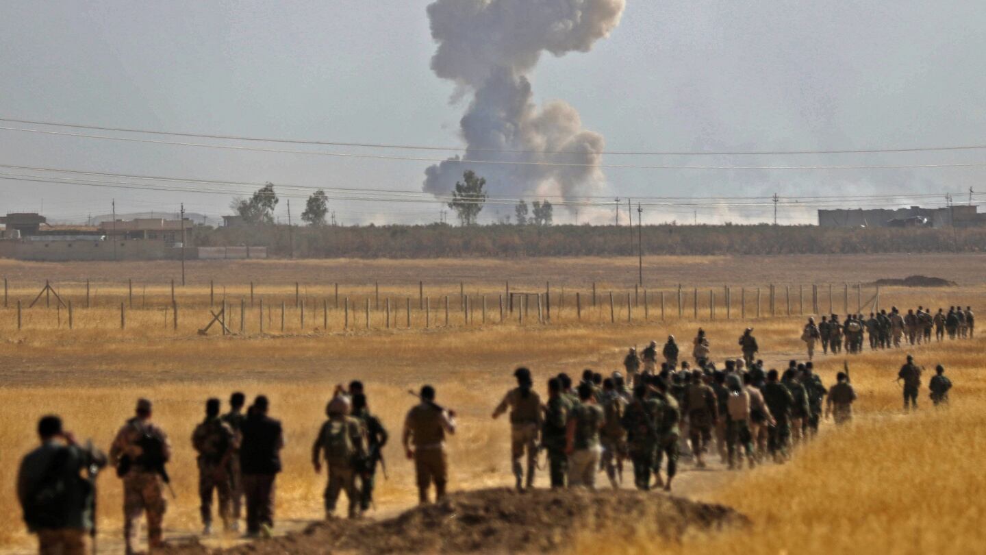 Smoke billows from an area near the Iraqi town of Nawaran, some 10km north east of Mosul, as Iraqi Kurdish Peshmerga fighters march down a dirt road on October 20th, 2016, during the ongoing operation to retake the city from the Islamic State group. The operation is Iraq’s biggest in years and aims to wrest back Mosul, the country’s second city and the last major Islamic State stronghold in Iraq. Photograph: Safin Hamedsafin/AFP/Getty Images