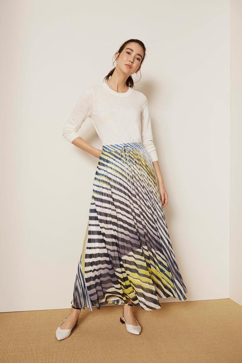 Mint Velvet’s white crew neck sweater €65, striped pleated maxi skirt €139, pointed flats €119 and hoop earrings €29