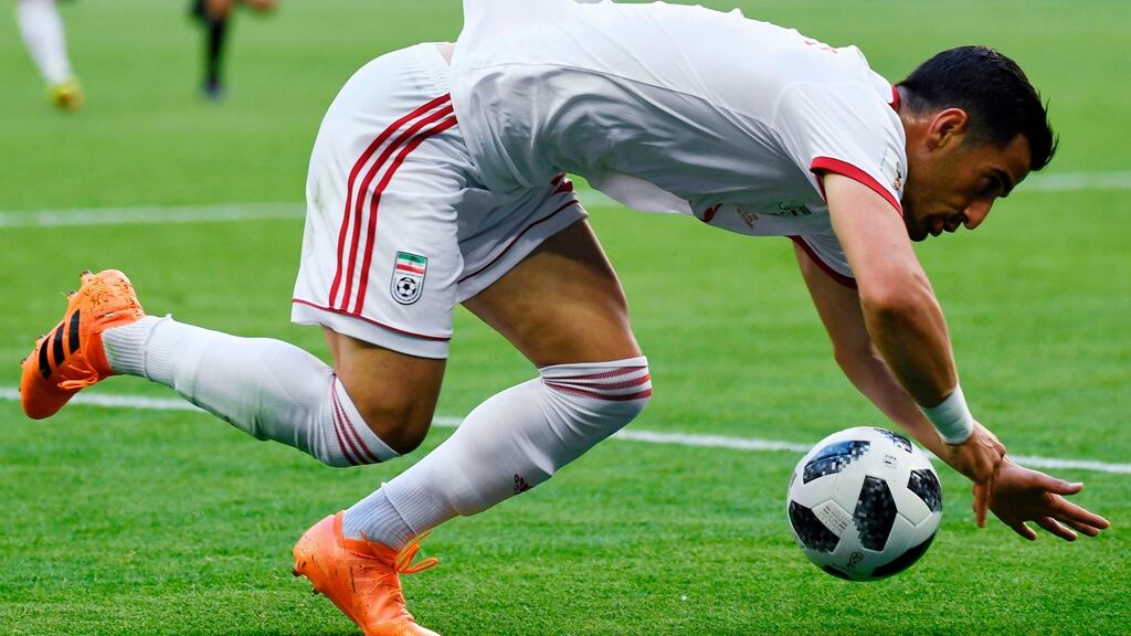 Iran’s midfielder Ehsan Haji Safi  during the  Group B  match between Morocco and Iran: Some of the tumbling  by the players during the game would have been awarded full marks if they had been gymnasts. Photograph: Getty Images
