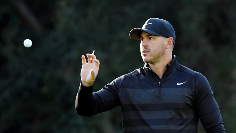 Brooks Koepka catches a ball on the 12th green during the first round of the Genesis Invitational in Pacific Palisades, California. Photograph: Harry How/Getty Images