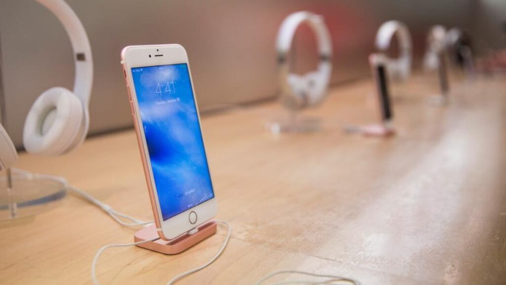 An iPhone sits on display inside the Apple store on Fifth Avenue, New York, in January 2016, when Apple reported the slowest iPhone earnings since 2007. Photograph: Andrew Burton/Getty Images