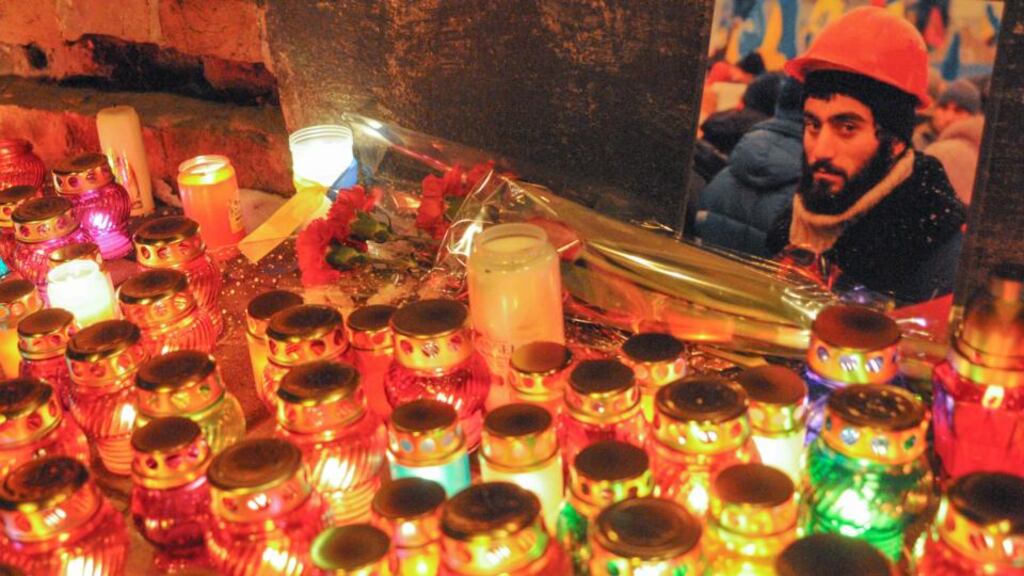 Ukrainians light candles during mourning ceremony for Sergey Nigoyan memory in west Ukrainian city of Lviv. Sergey Nigoyan was killed by gunfire yesterday morning  in Kiev. Photograph: Markiian Lyseiko/EPA
