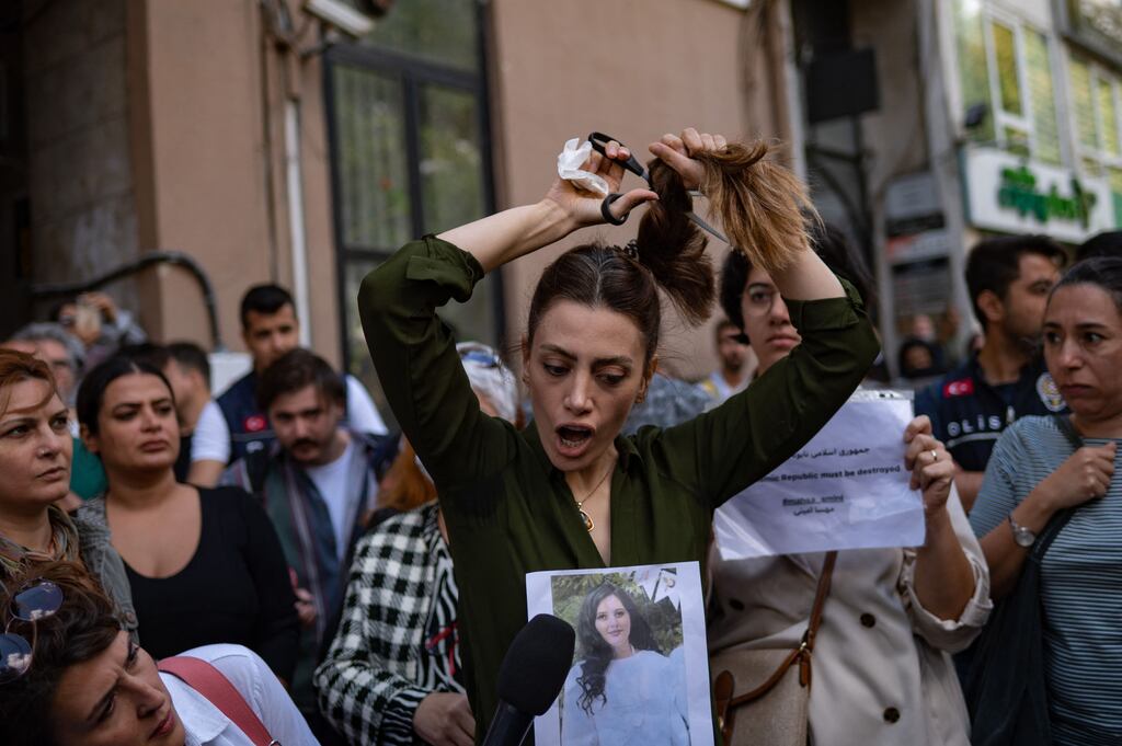Nasibe Samsaei, an Iranian woman living in Turkey, cuts her ponytail off during a protest outside the Iranian consulate in Istanbul following the death of Mahsa Amini while in custody in Tehran. Ms Amini (22), was detained by the police unit responsible for enforcing Iran's strict dress code for women, including the wearing of the headscarf in public. Photograph: Yasin Akgul/Getty Images